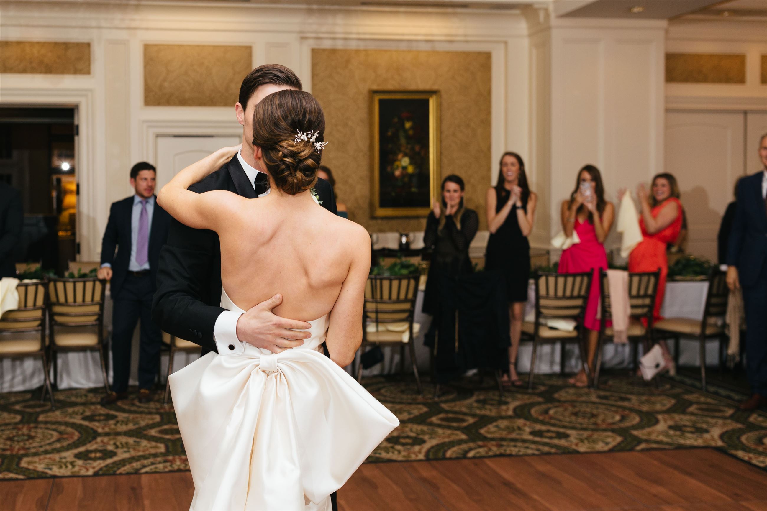 bride and groom dancing in front of people at wedding