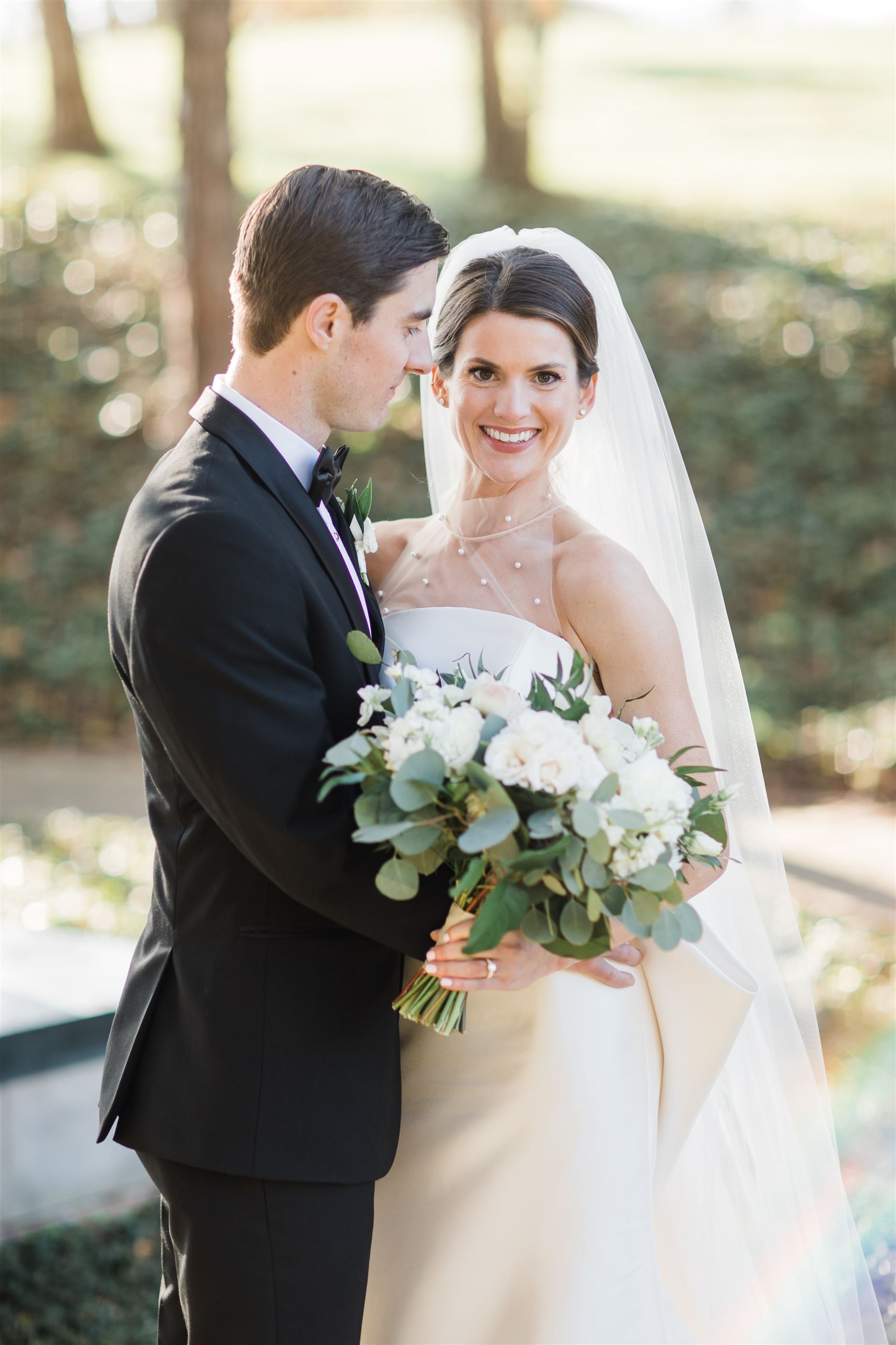 bride smiling to camera and groom looking at her