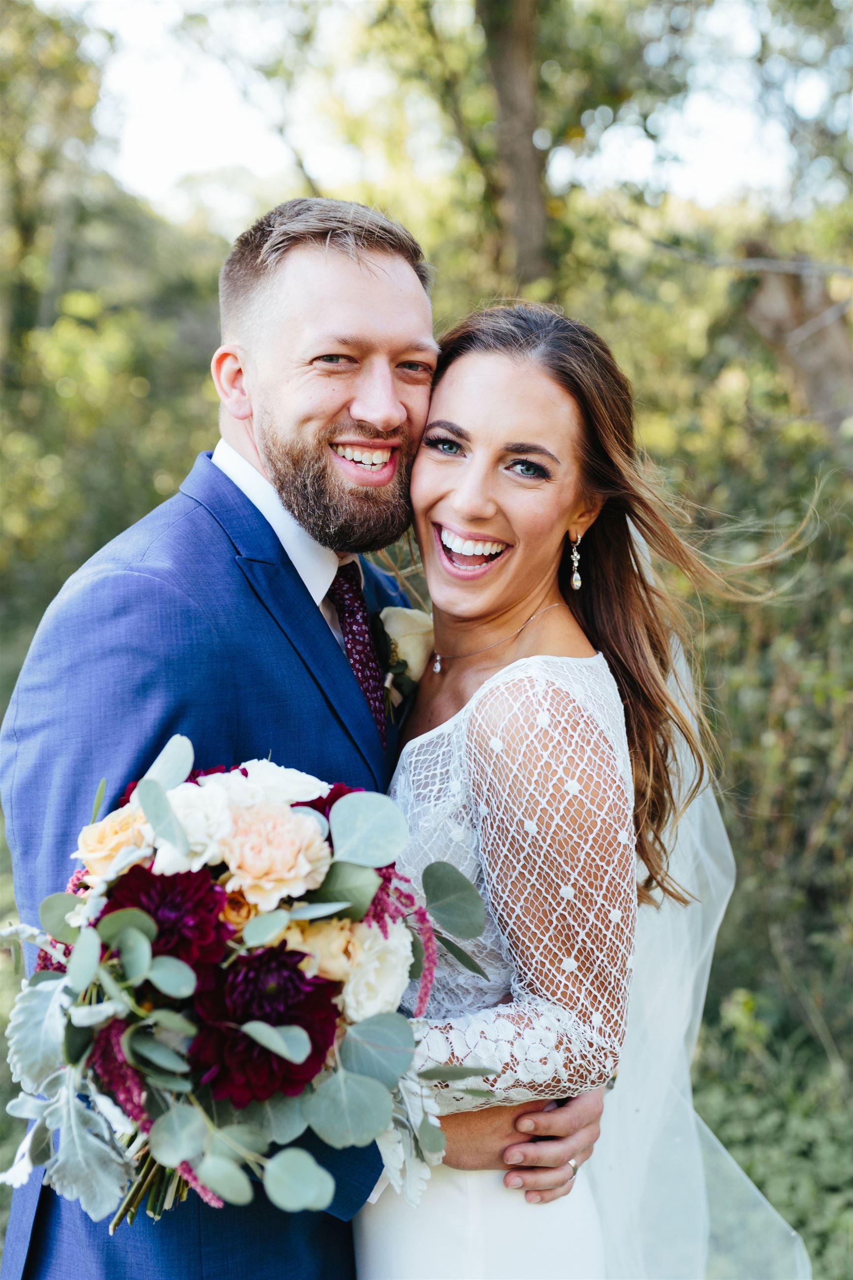 bride and groom smiling into camera