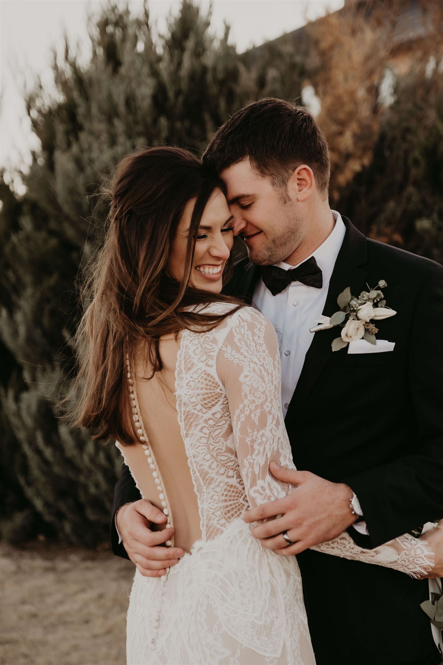 Bride Wearing Detailed Dress And Hugging Groom