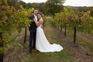 Bride And Groom Standing In Vineyard