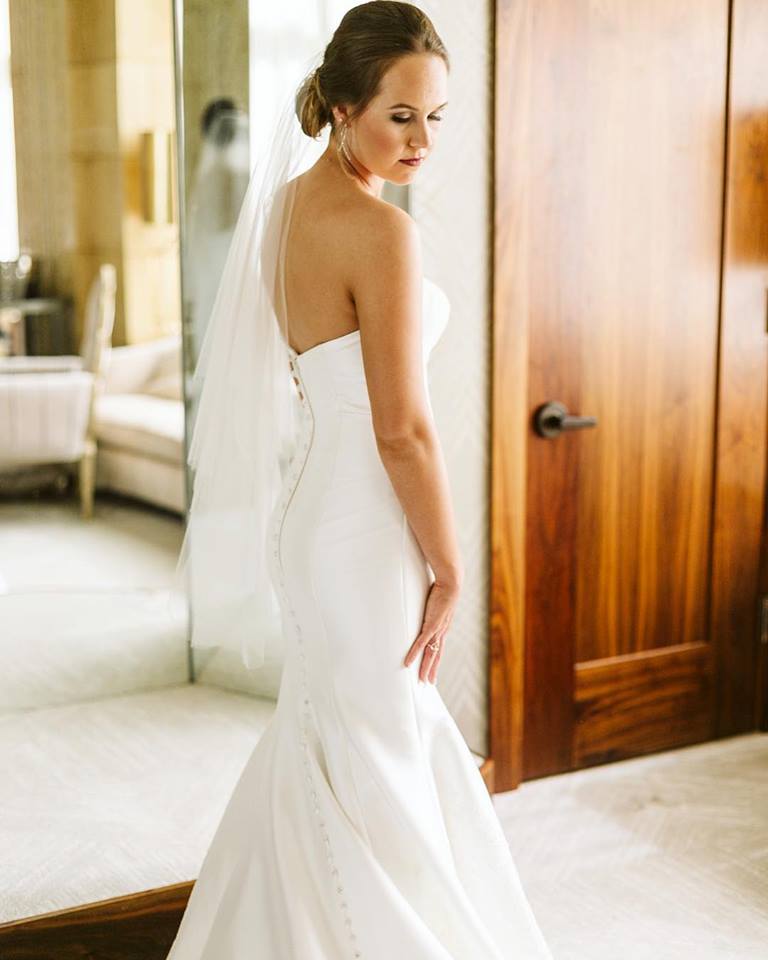 Bride Looking Over Shoulder Wearing White Wedding Dress